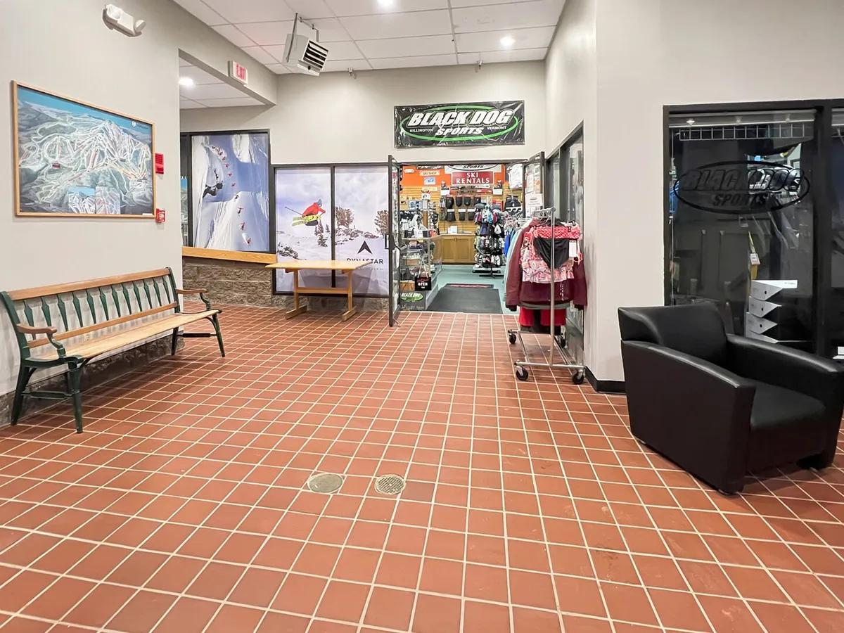 A lively interior view of the resort’s sporting goods store and reception area. Shelves and displays present gear for skiing and snowboarding, with guests browsing and preparing for winter adventures.
